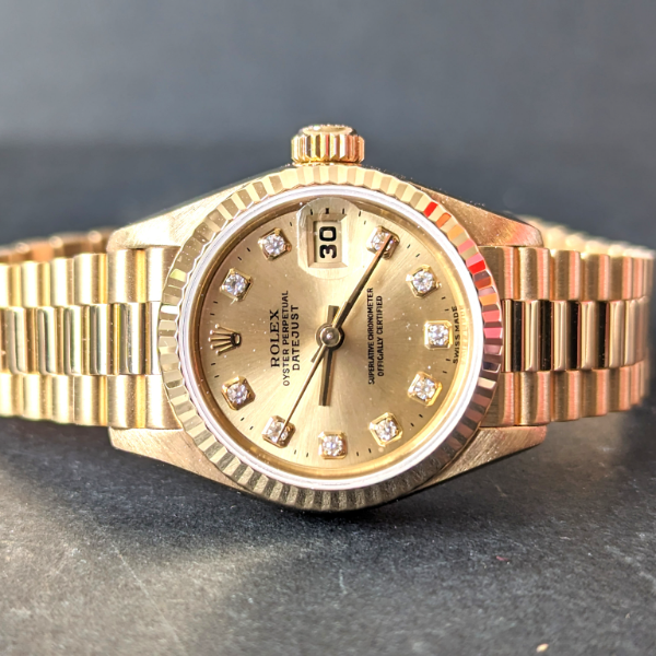 Lady's gold Rolex with Diamonds front