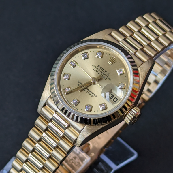 Lady's gold Rolex with Diamonds dial