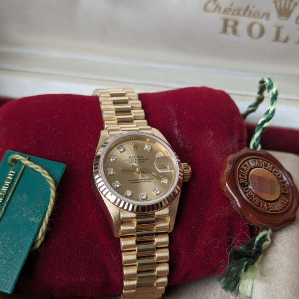 Lady's gold Rolex with Diamonds bracelet