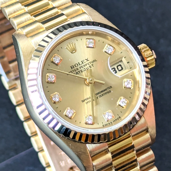 Lady's gold Rolex with Diamonds clasp