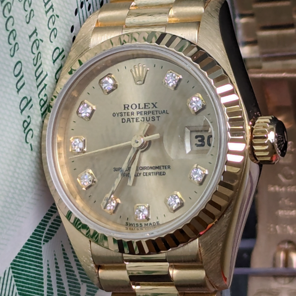 Lady's gold Rolex with Diamonds