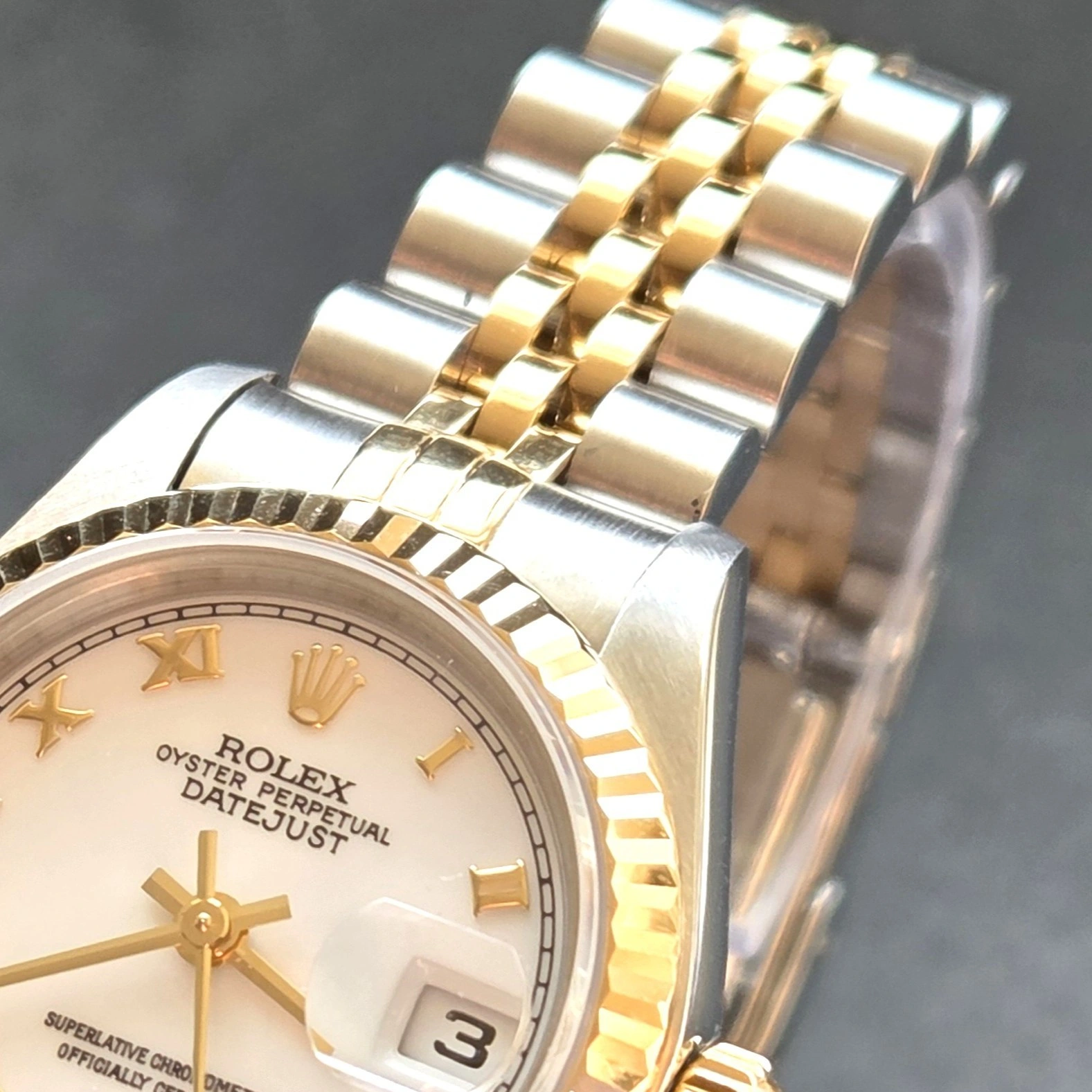 Gold Roman Numerals on crisp White Dial   side